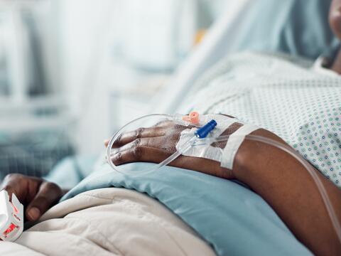 Close up of a hospital patient's hand with an  IV